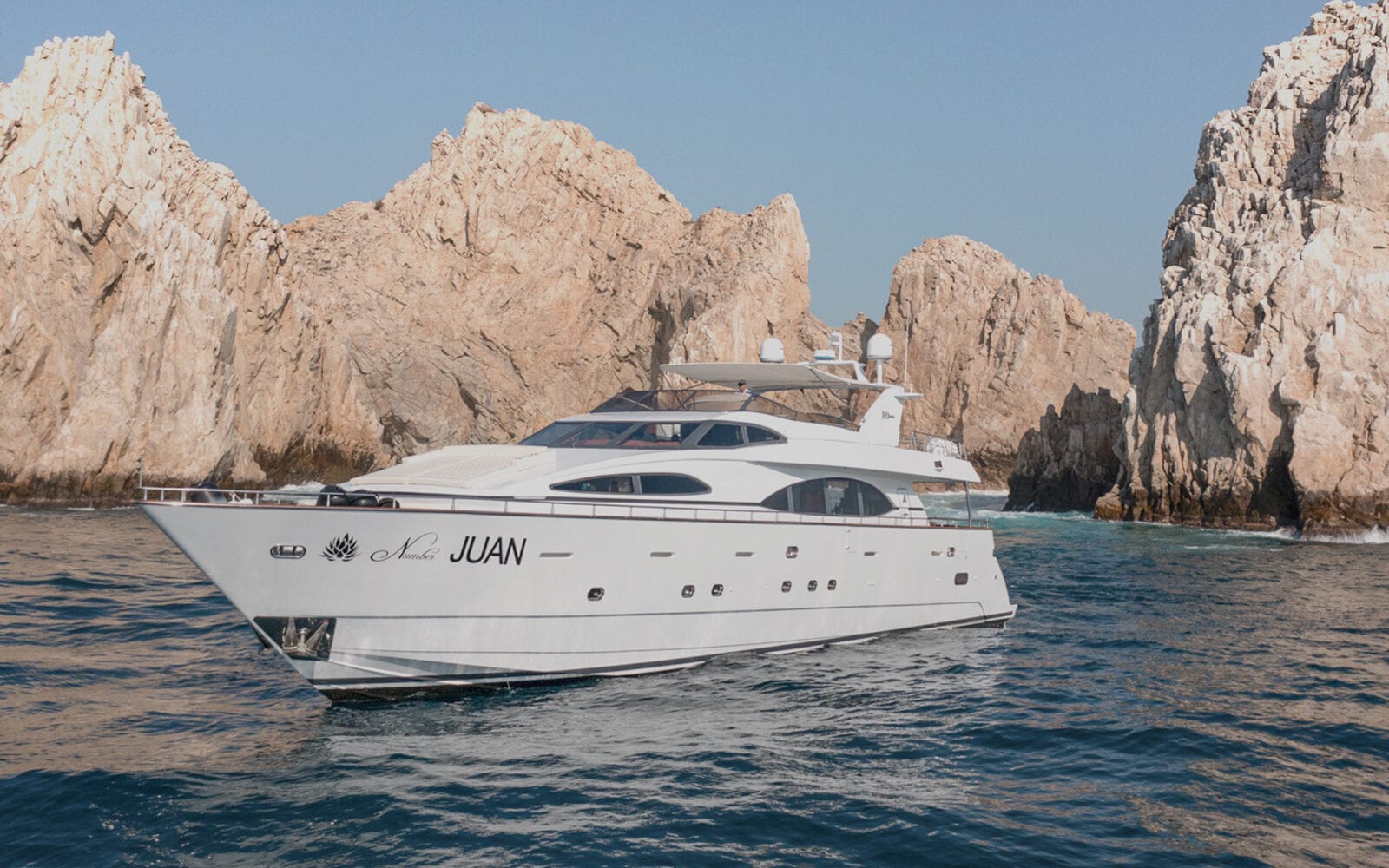 Private yacht fleet cruising near Cabo San Lucas at sunset